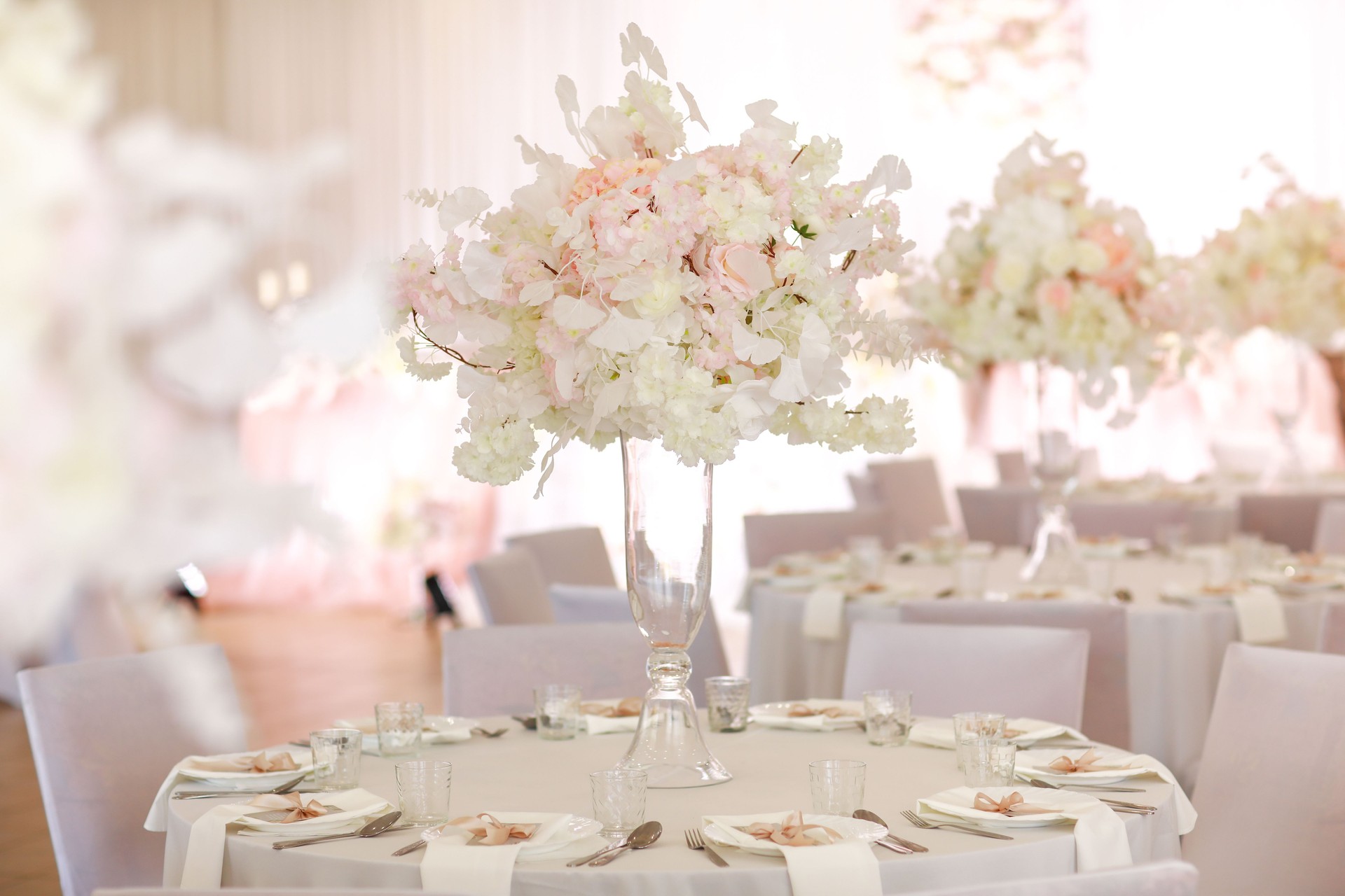 festive wedding decoration. Beautiful fresh white and pink flowers in glass vase on dining table on wedding day. High quality photo